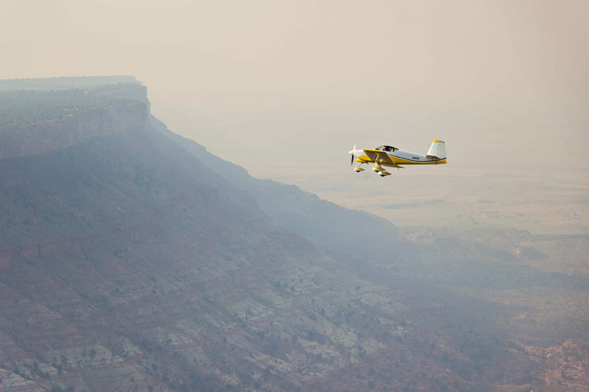 Tour plane flying over bluff