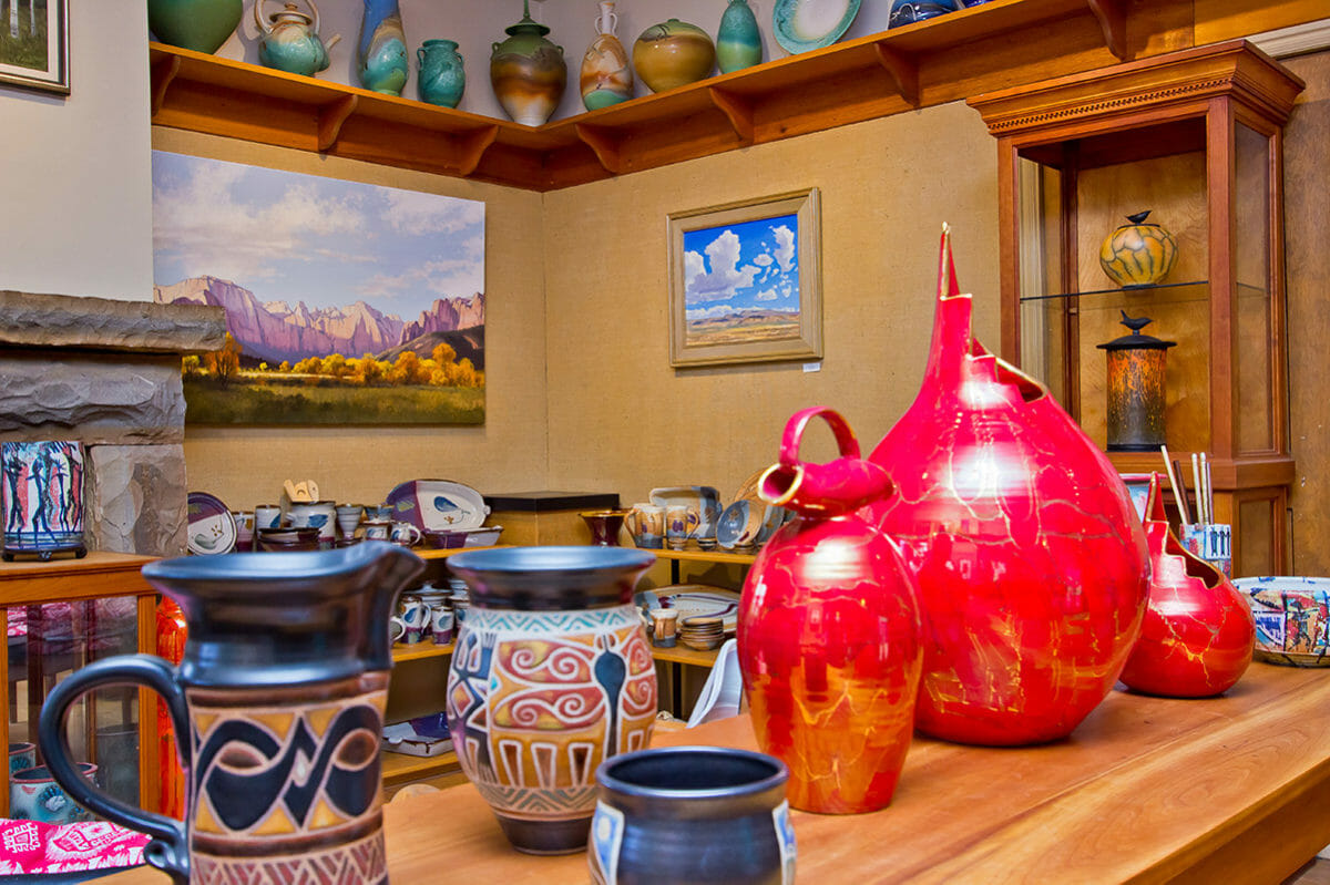 Brightly-colored pottery on display in an art gallery.