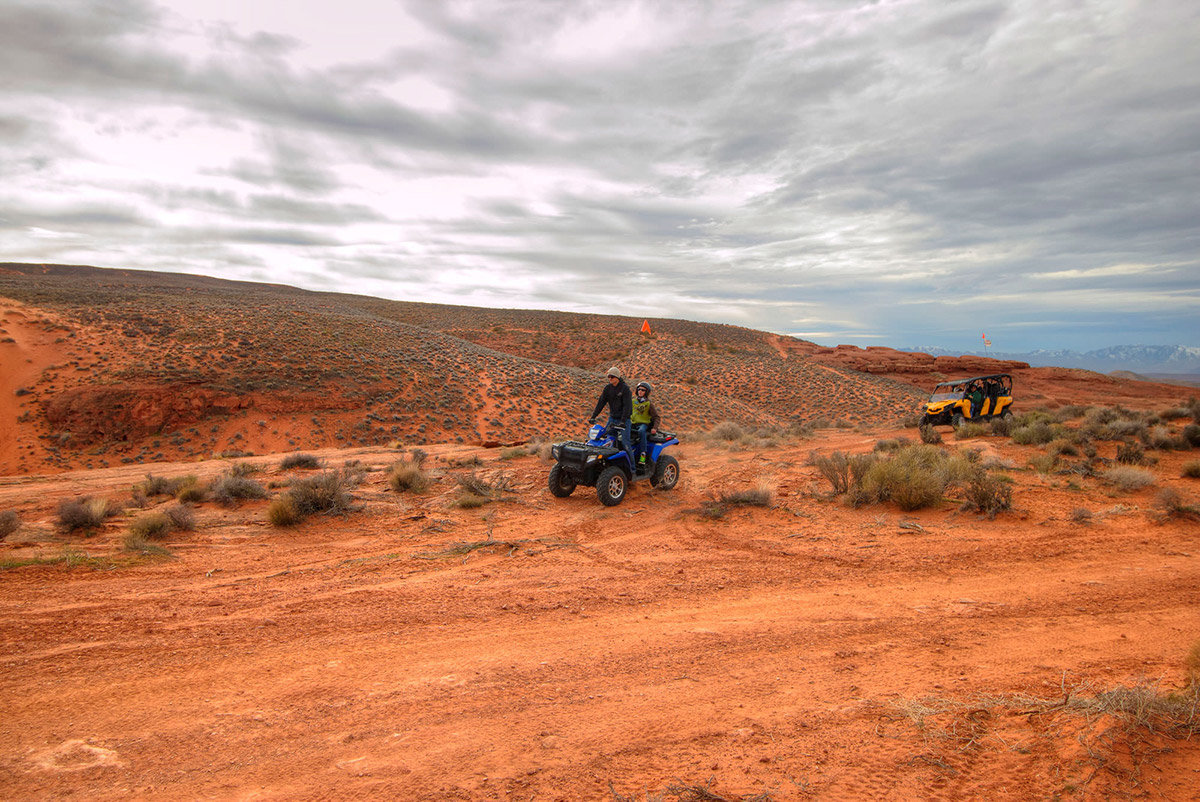 Man on ATV being followed by an OHV