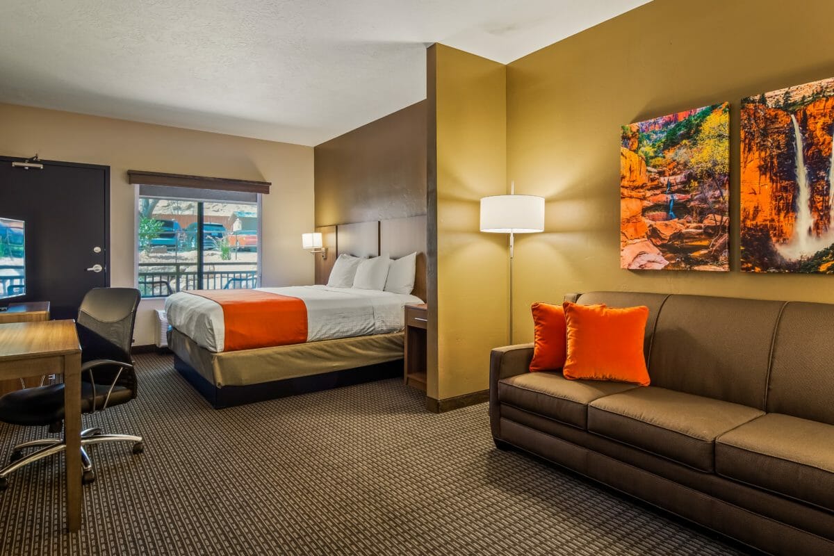 Modern hotel room with king bed and sofa