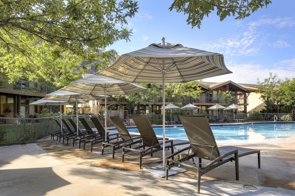 Lounge chairs and umbrellas around pool