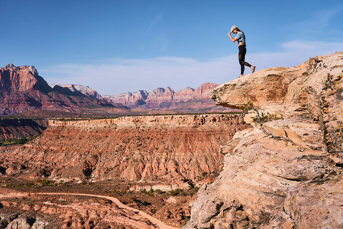 Woman standing at the edge of a bluff.