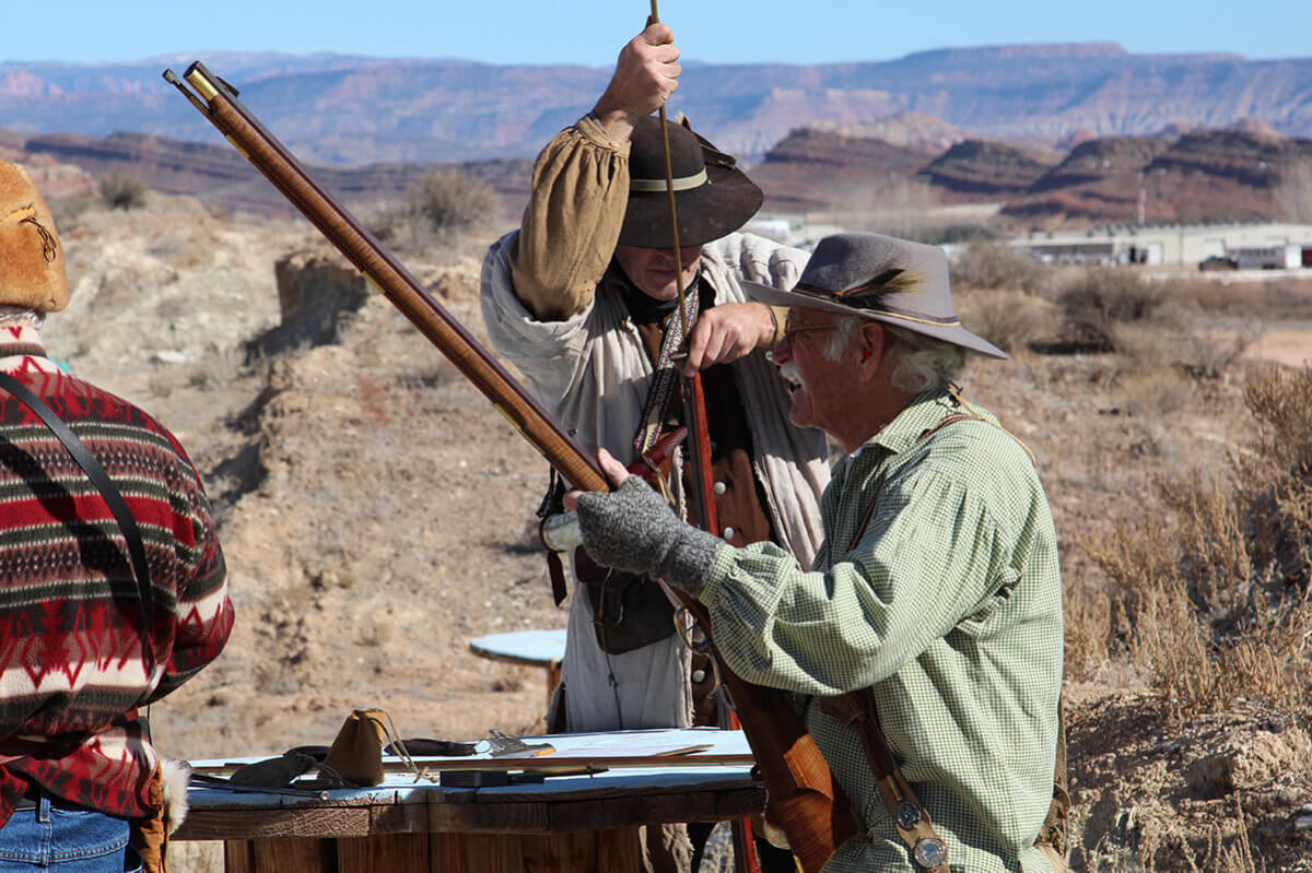 Men loading black powder rifles