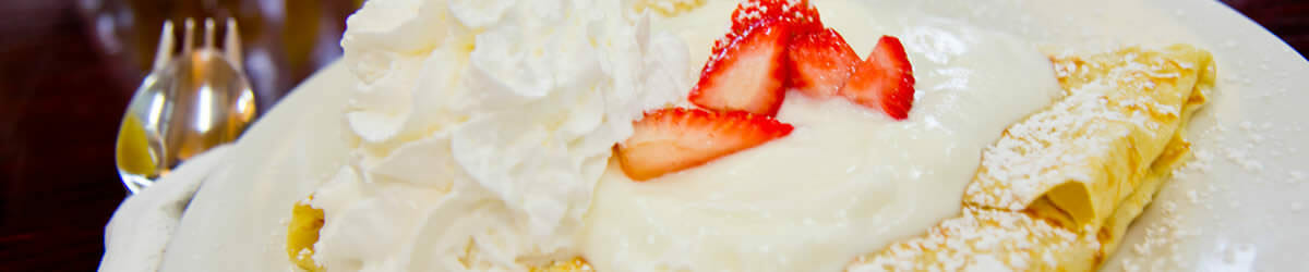 Crepe with strawberries and whipped cream.