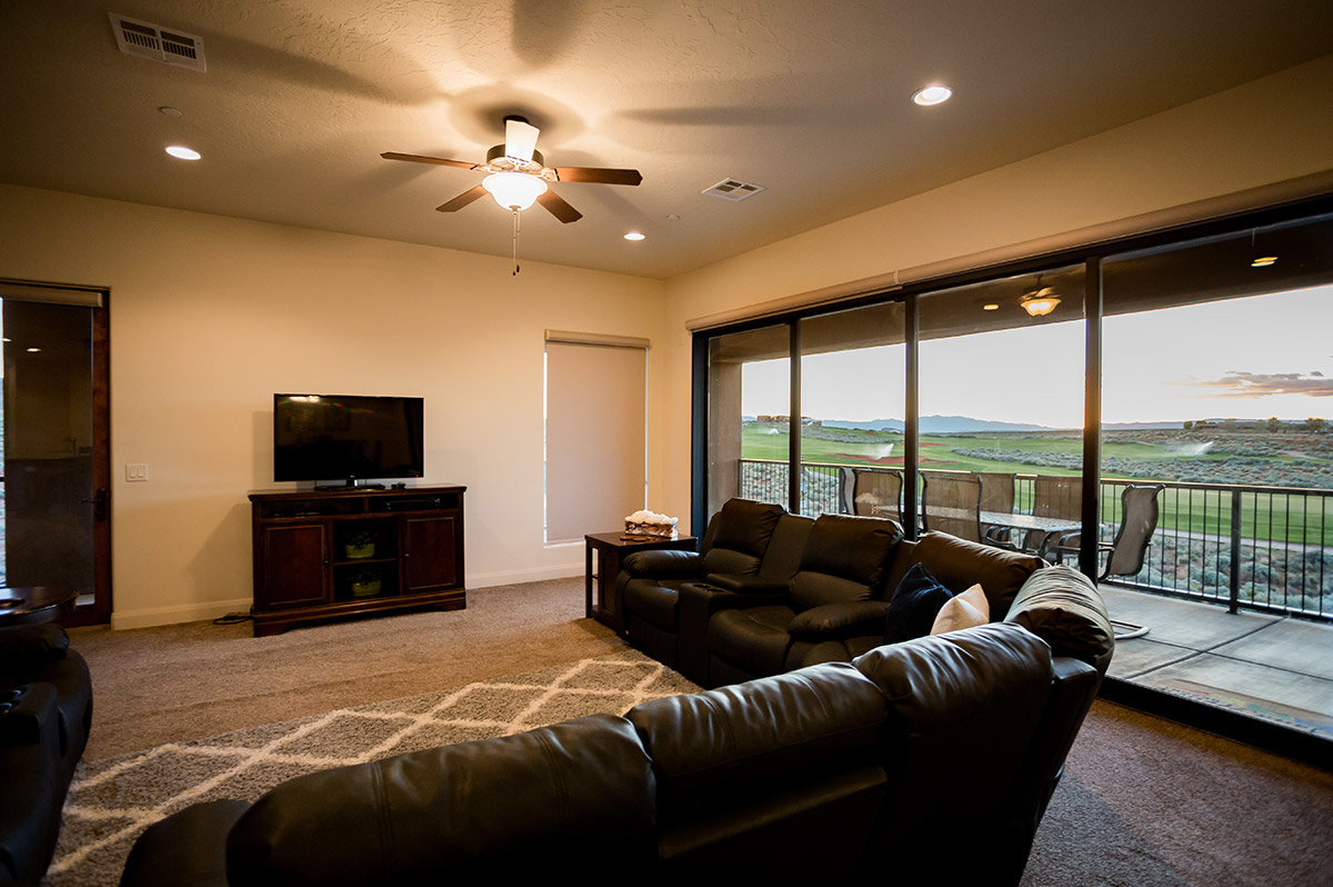Brown leather sectional sofa in hotel suite with view of golf course