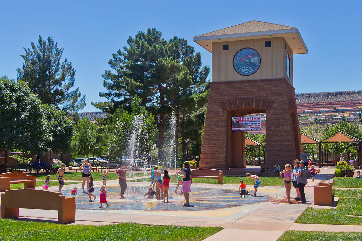 Kids playing on splash pad at local park.
