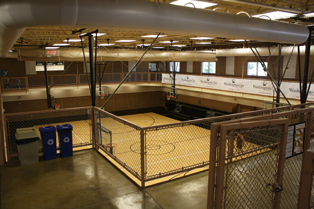 View of second story floor above indoor basketball court