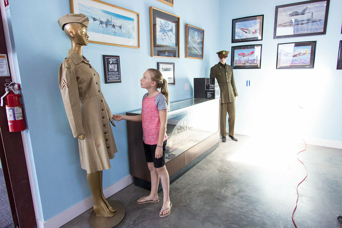 Young girl admiring historic aviation uniforms