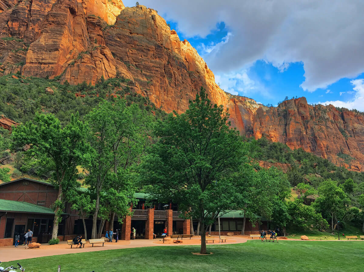 Mountain lodge with towering cliffs behind